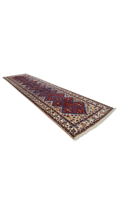 Oriental runner rug with geometric diamonds in shades of blue and red on beige
