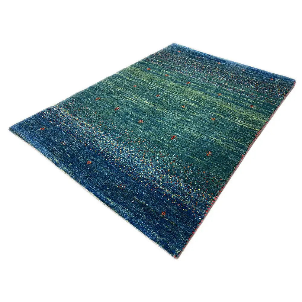 Gabbeh rug 91x63 cm, laid at an angle: green-blue/dark blue with red and yellow accents