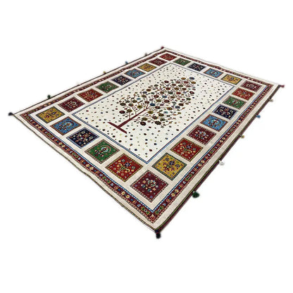 Rug with a white background, a central tree, and a colorful tiled decorative border