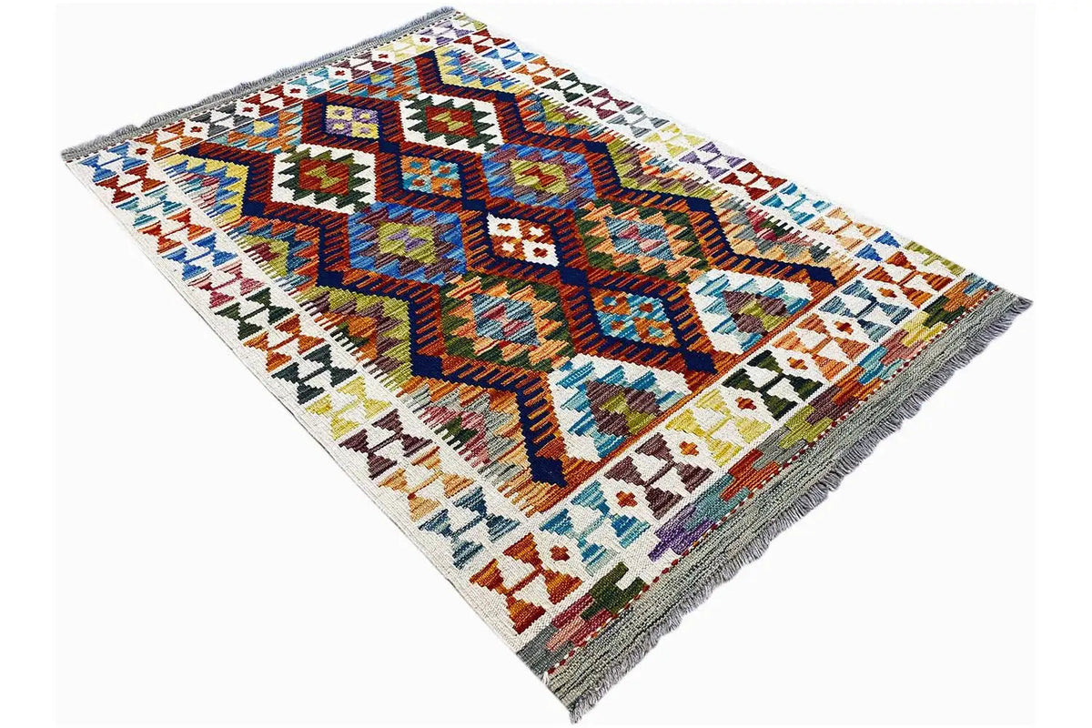Angled kilim rug with a multicolored tribal pattern, white background, and fringes