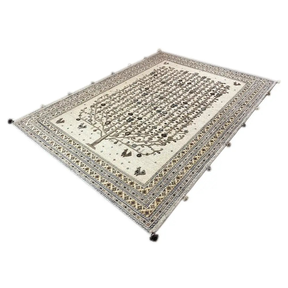 Top view of a rug with a tree motif and delicate border, light beige background with dark details