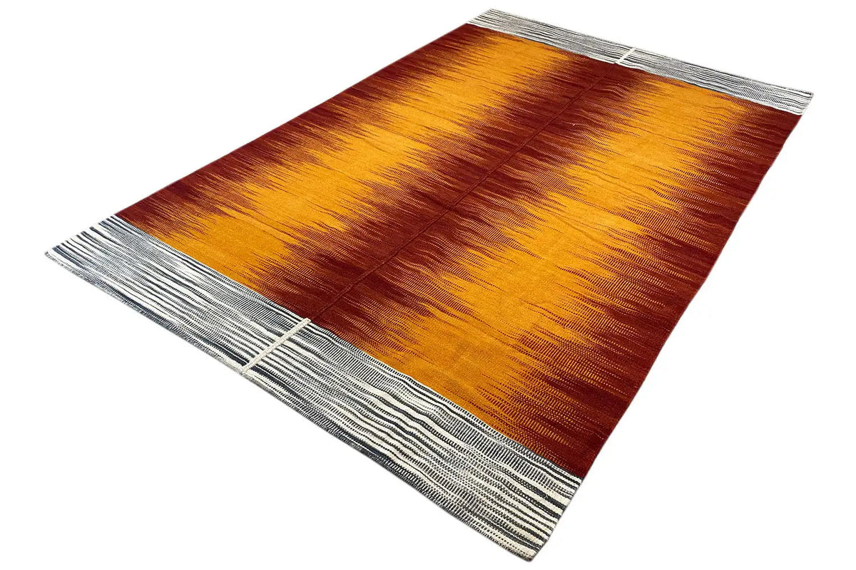 Kilim rug lying at an angle, orange-red striped pattern with a gray border