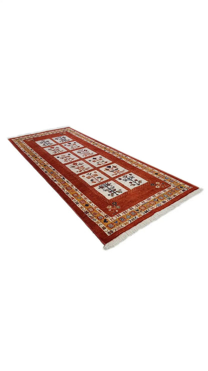Rectangular Oriental rug in reddish brown with a geometric field pattern.