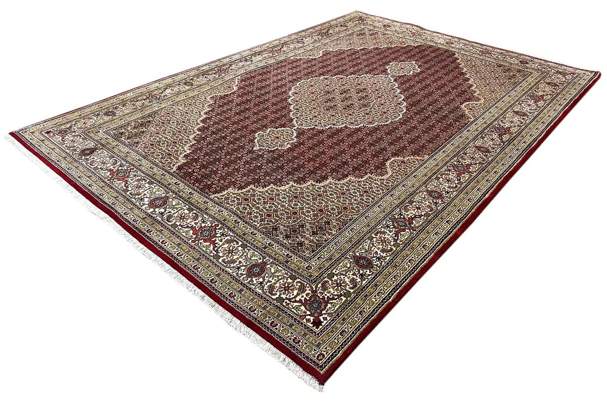Indo Tabriz carpet, laid diagonally, burgundy center with a rosette-like medallion