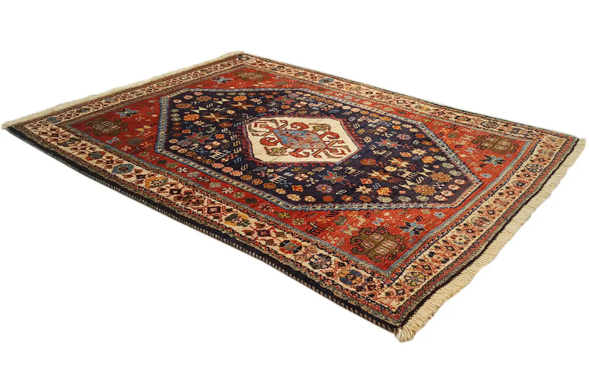 Oriental rug with a red outer field, dark blue, and finely woven border