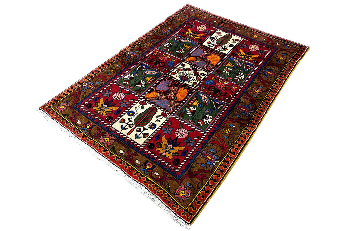 Bakhtiari rug, spread diagonally; many patterned panels with a red center