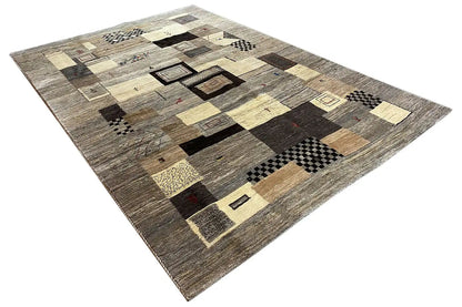 Gabbeh rug with a block pattern in beige, dark brown, and black, with a mottled texture
