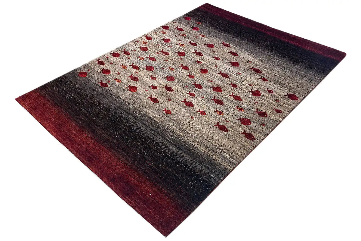 Gabbeh rug, angled view, beige pile with red dots and dark brown areas