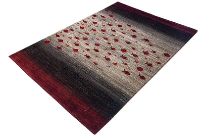 Gabbeh rug, angled view, beige pile with red dots and dark brown areas