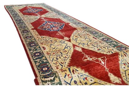 Oriental rug at an angle: red patterned field with a blue border and decorative motifs