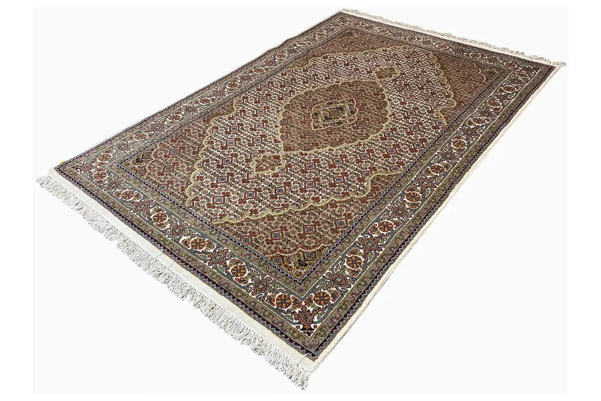 Oriental rug laid flat with a central medallion, dark pile, and white fringes