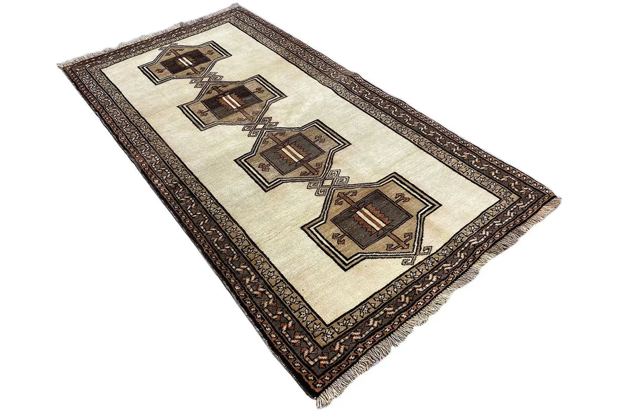 Oriental rug with a beige field, diagonal medallion pattern, and dark border.