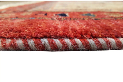 Edge fringes of an Oriental rug with a red pile and a dark decorative line along the hem.