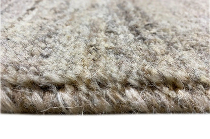 Gabbeh rug: dense pile texture in light gray and cream, close-up