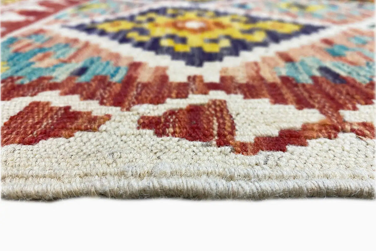 Close-up of a kilim runner: selvedge fringe and a bold geometric pattern