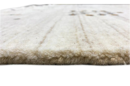 Light beige carpet with a fringed edge and pile in close-up