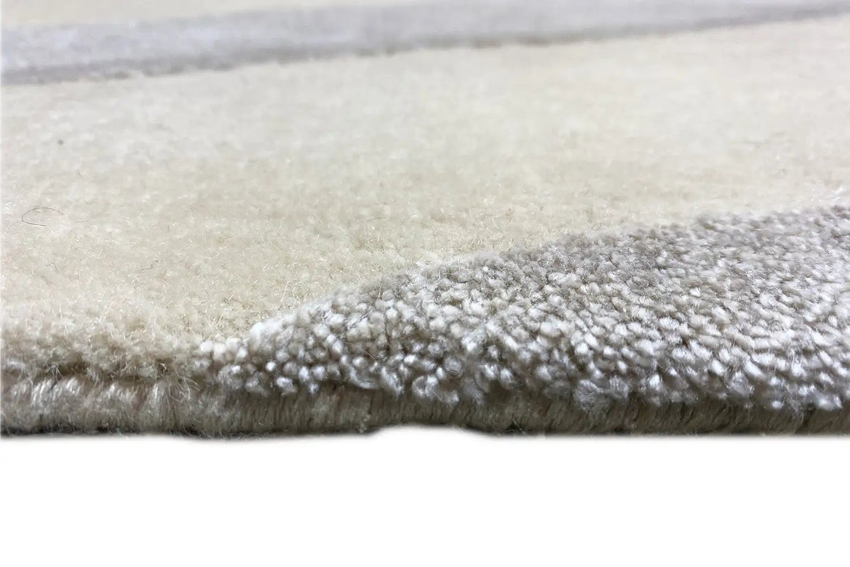 Short, dense pile along the edge, light beige background