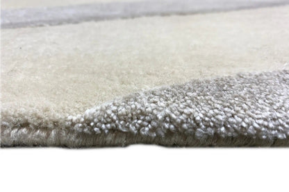 Short, dense pile along the edge, light beige background