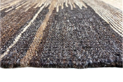 Close-up of a kilim rug with a dense texture and lengthwise stripes.