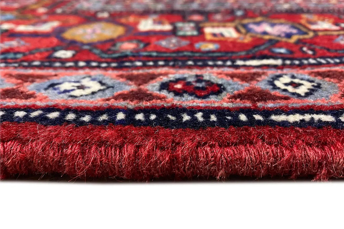 Carpet edge with fringed finish, red and blue pattern in detail