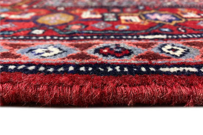 Carpet edge with fringed finish, red and blue pattern in detail
