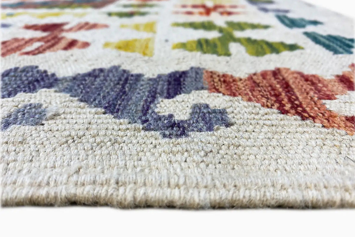 Kilim detail: multicolored patterned border with fringes along the lower edge