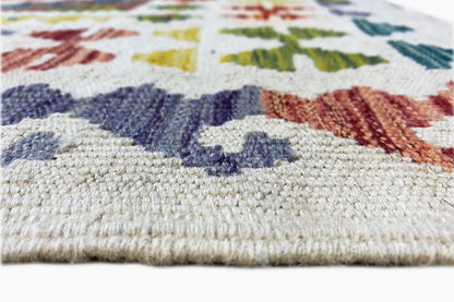 Kilim detail: multicolored patterned border with fringes along the lower edge