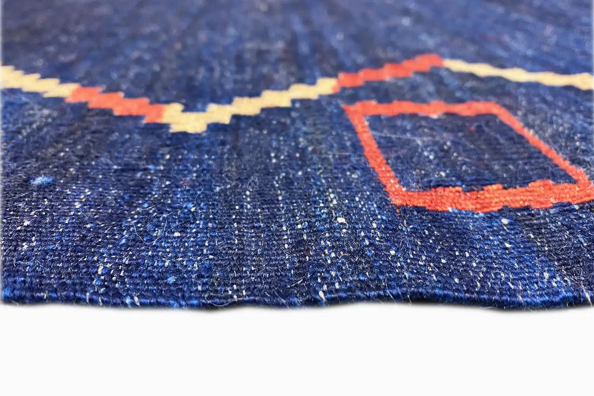 Qashqai kilim rug: blue pile texture with an orange rectangular pattern