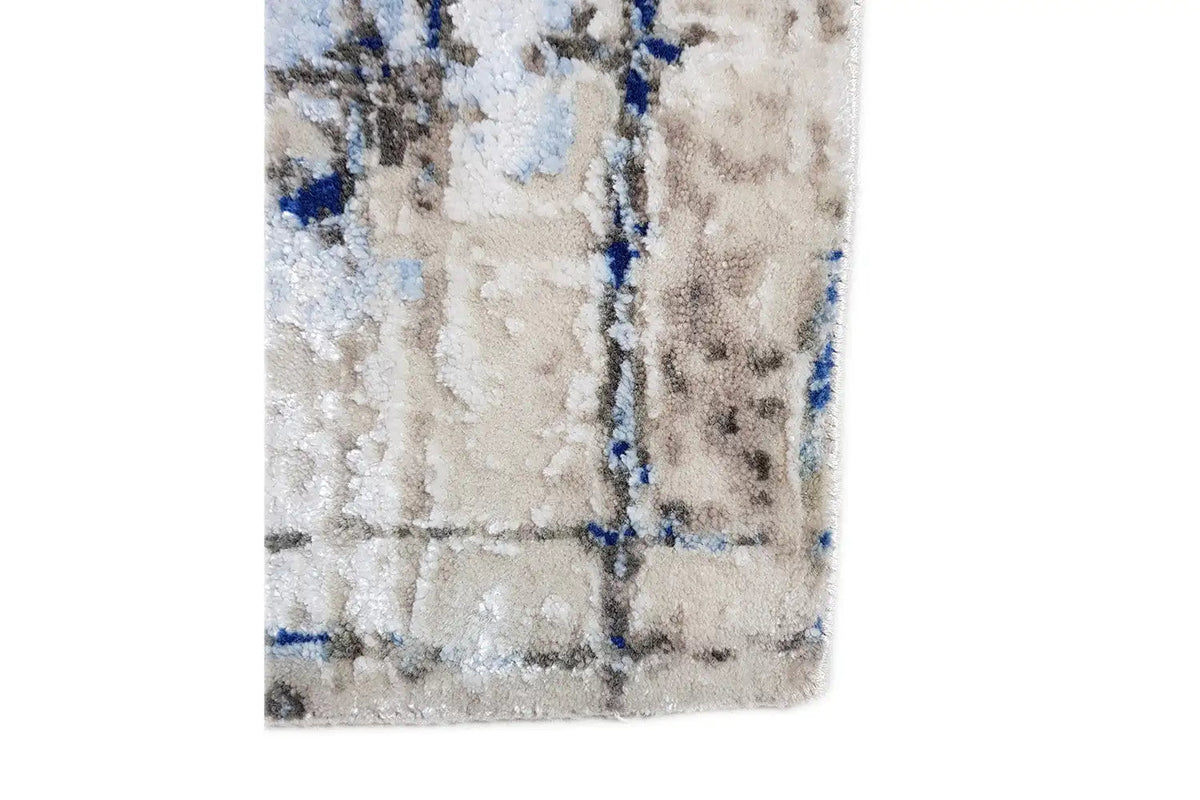 Front of a rug with a light-colored pattern and scattered blue lines