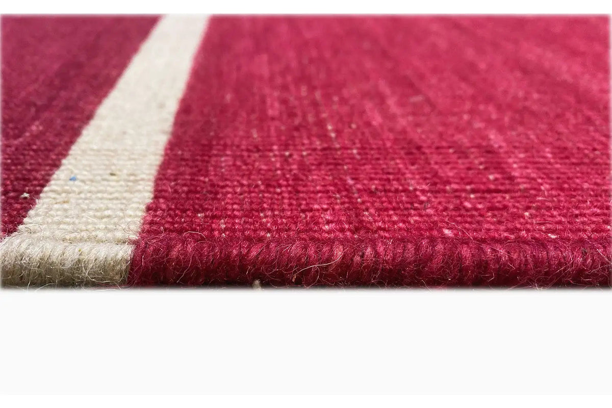 Red kilim edge with fringes and beige finishing band, woven texture