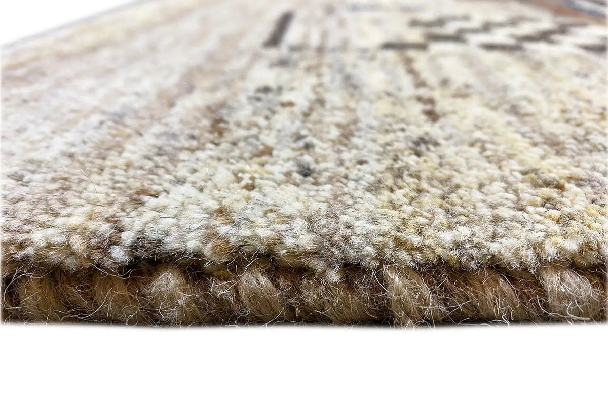 Carpet pile in detail: dense, beige pile with a wide border