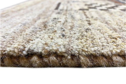 Carpet pile in detail: dense, beige pile with a wide border