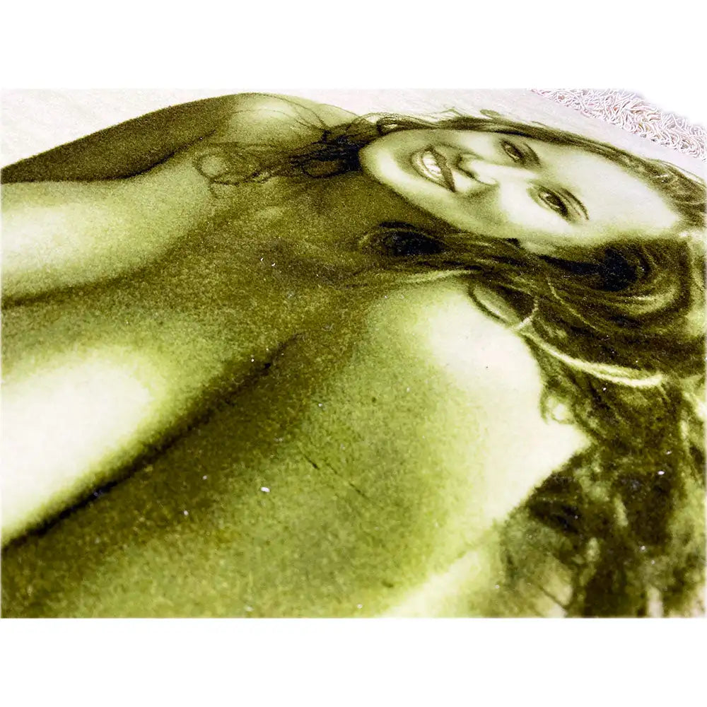 Close-up of a tapestry with a photo of a woman, printed in light green