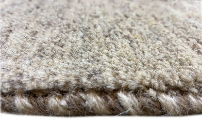 Gabbeh rug: dense high-pile weave in light beige with a visible rug edge.