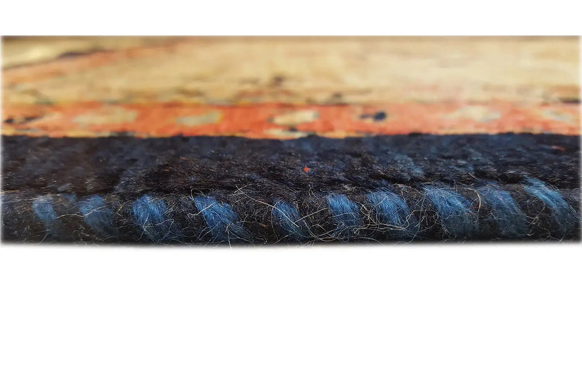 Carpet pile in detail: dark area with beige and blue color accents, close-up