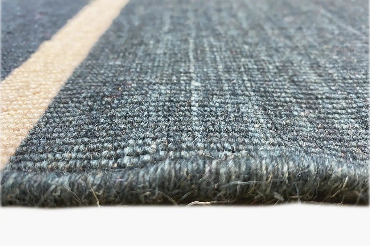 Close-up of the edges: Kilim with fringes and sturdy stitching, dark blue/beige