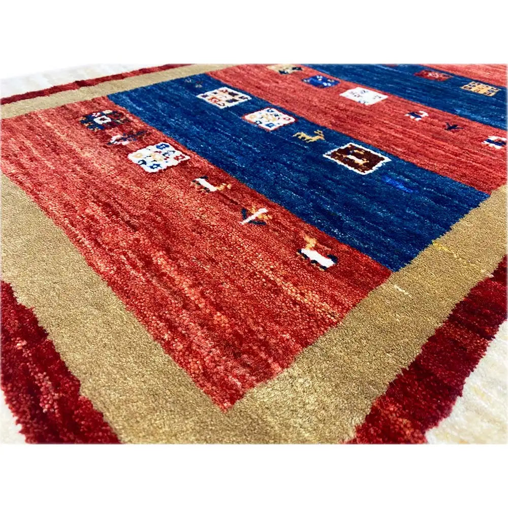 Close-up: Gabbeh rug with a red and blue pattern and multicolored ornaments