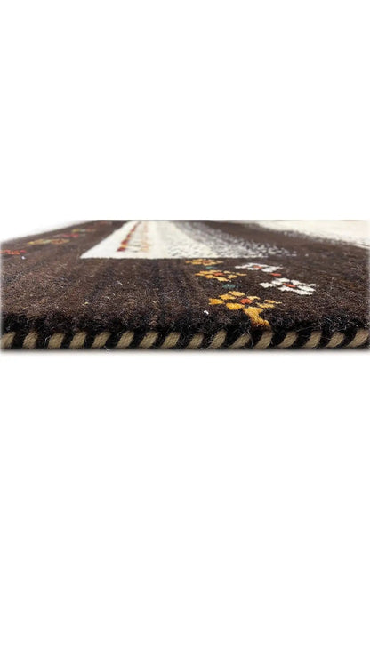 Gabbeh rug with dark brown pile, cream decorative stripes, and yellow-red accents