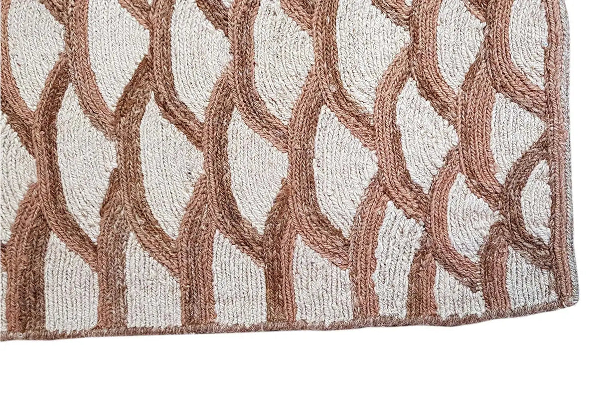 Close-up of a carpet pattern: white arcs with brown shading