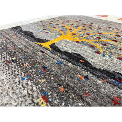 Gabbeh Lori rug: close-up view with a yellow tree, colorful accents, and textured wool