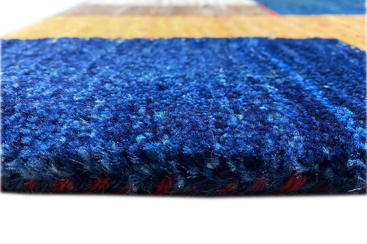 Gabbeh rug: close-up of the dense blue pile at the edge
