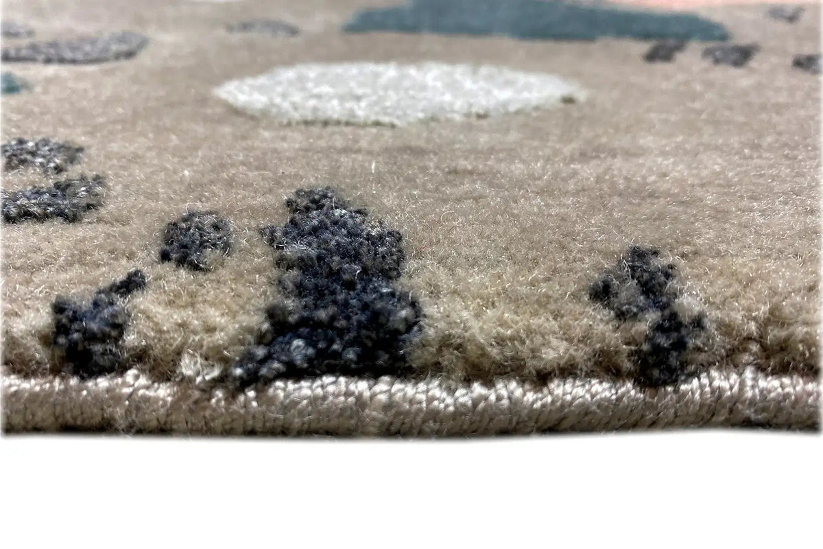 Close-up: beige carpet with dark and colorful patterns, soft pile surface