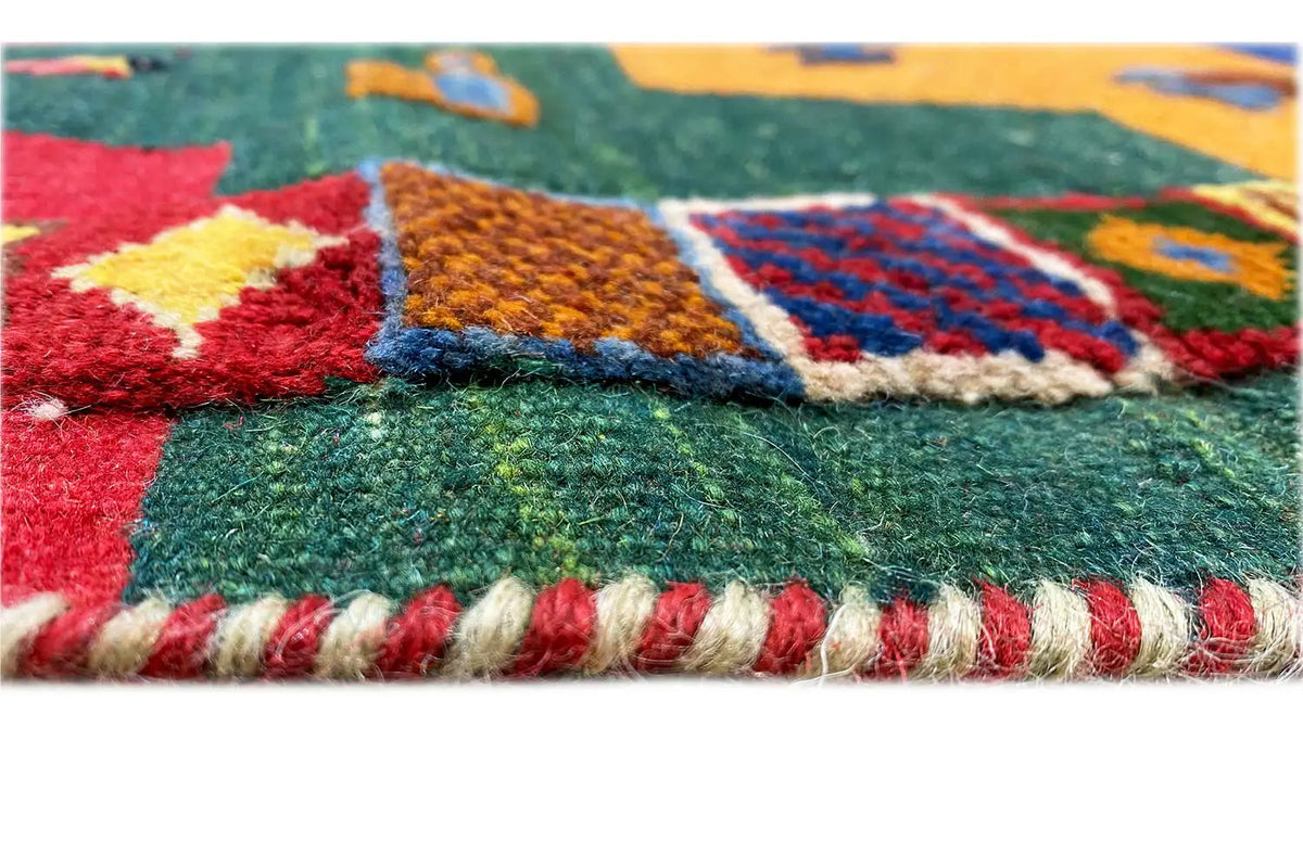 Detail of the edge with a fringed finish and colorful geometric patterns