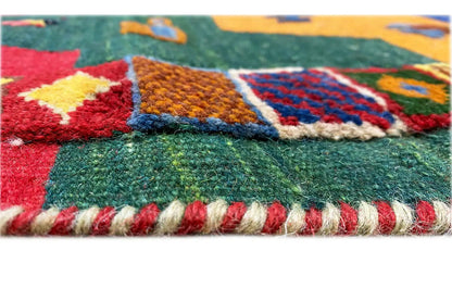 Detail of the edge with a fringed finish and colorful geometric patterns