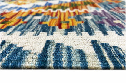 Kilim runner: detail of the fringes and woven pile with blue and white stripes.