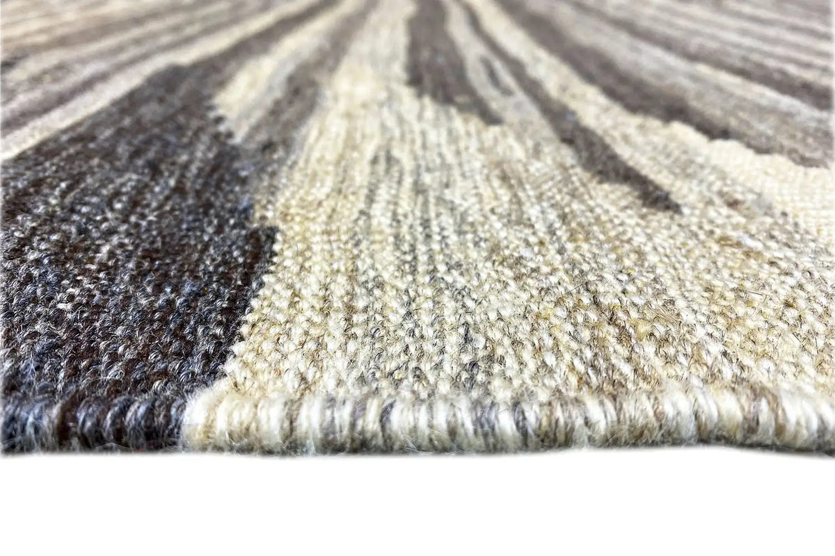 Kilim Qashqai close-up: high-pile texture and fringes, predominantly beige with dark stripes