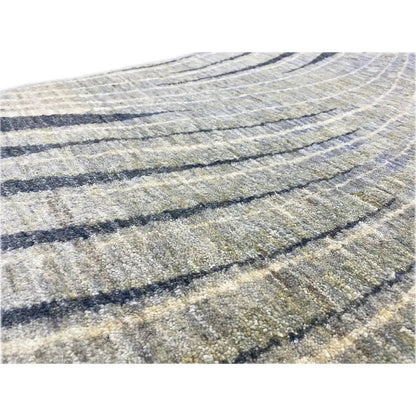 Close-up of a Gabbeh rug: beige pile with dark blue lines and a fine texture