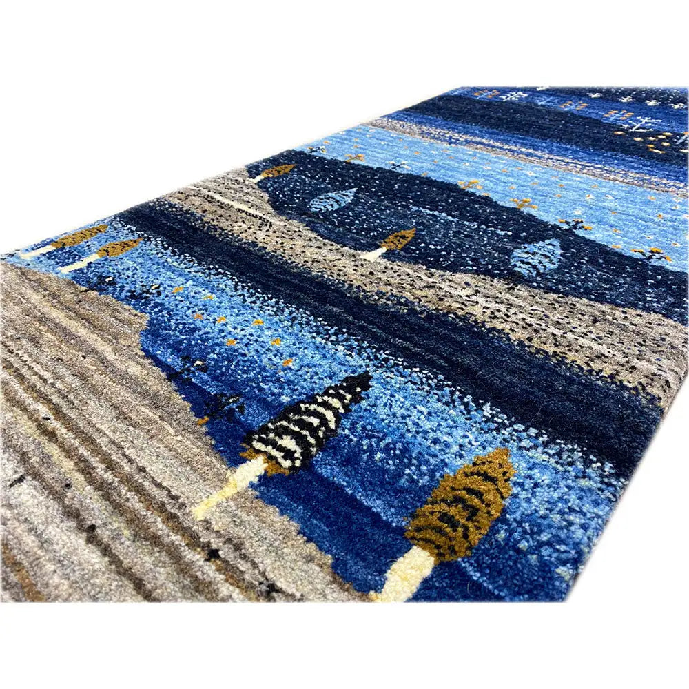 Gabbeh runner rug detail: blue areas, beige stripes, ornamental trees
