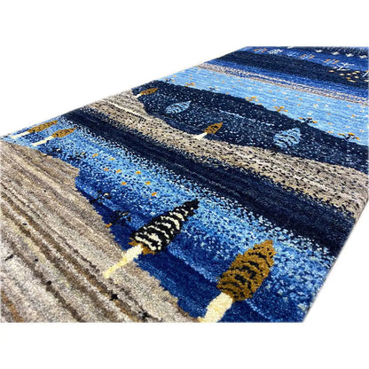 Gabbeh runner rug detail: blue areas, beige stripes, ornamental trees