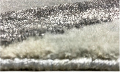 Close-up of the carpet pile: short, patterned pile in shades of gray and dark tones